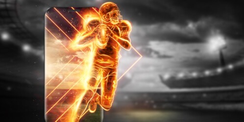 A,silhouette,of,an,american,football,player,on,fire,crawls