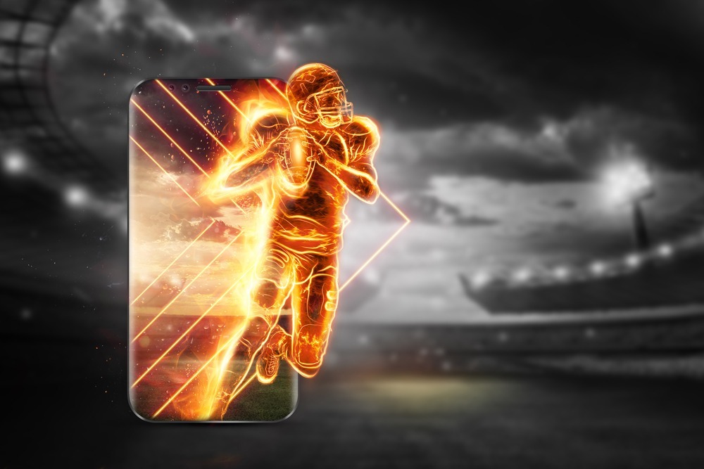 A,silhouette,of,an,american,football,player,on,fire,crawls