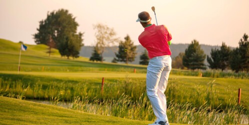 Man,playing,golf,against,sunset