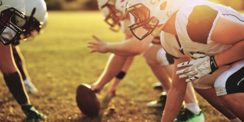 Group,of,young,american,football,players,practicing,offensive,drills,outside