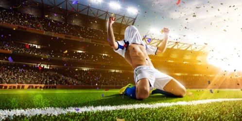 Soccer,player,in,action,on,night,stadium,panorama,background