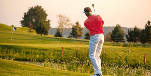 Man,playing,golf,against,sunset